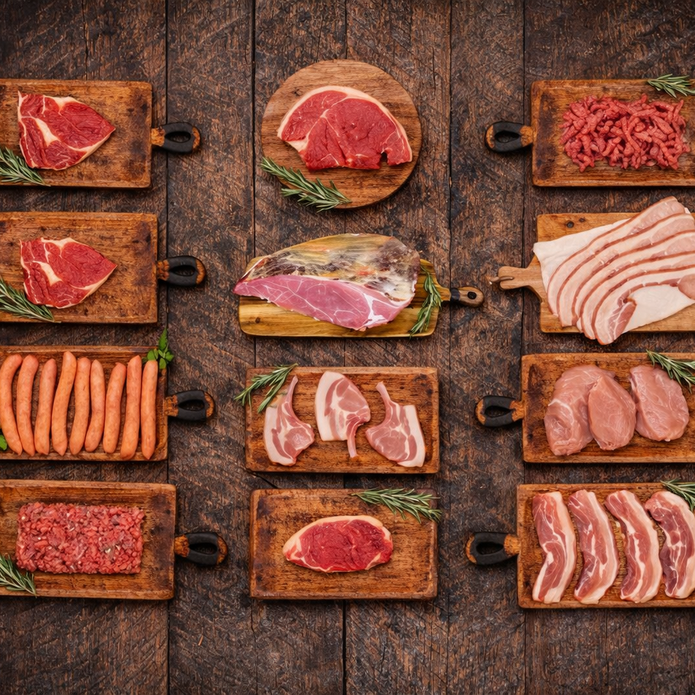Assorted types of raw meat on wooden cutting boards against a rustic wooden background